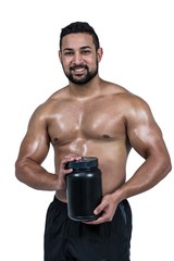 Muscular man with protein powder
