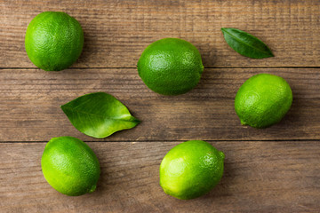 Fresh limes on wooden background