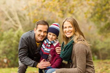 Smiling young couple with little boy posing