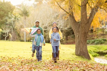 Fototapeta premium Young family playing with a kite