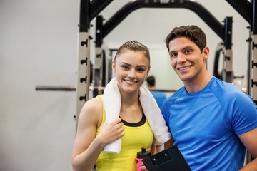 Fototapeta na wymiar Trainer and woman discussing workout plan