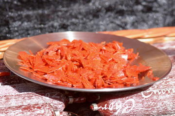 Small slices of chorizo sausage on plate to sample at food festival