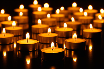 Many burning candles with shallow depth of field