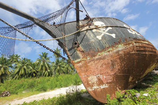 Rusty old pirate ship on the shore of the island. La Digue