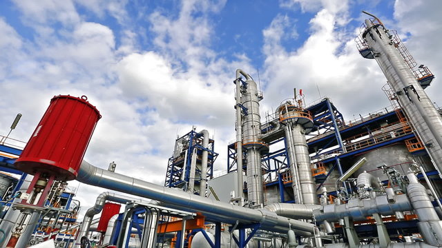 Time lapse of Refinery tower structure in process area of refinery plant with blue sky 