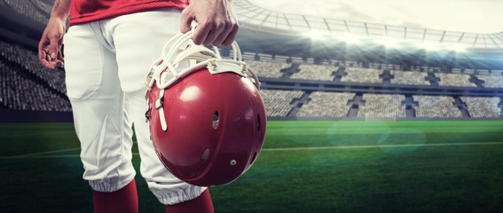 Composite image of an american football player taking his helmet