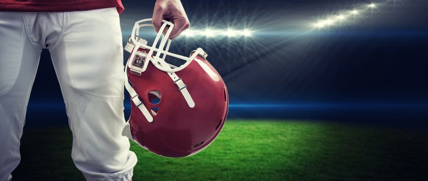 Composite image of an american football player taking his helmet