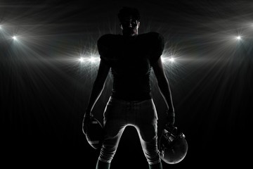 Composite image of silhouette american football player - Powered by Adobe