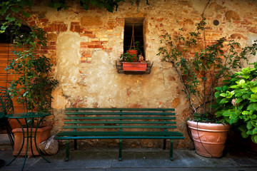 Retro bench outside old Italian house in a small town of Pienza, Italy. Vintage