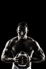 Fototapeta na wymiar Composite image of shirtless american football player with ball