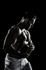 Obraz na płótnie Canvas Composite image of shirtless american football player with ball