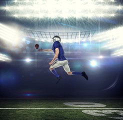 American football player trying to catch the ball