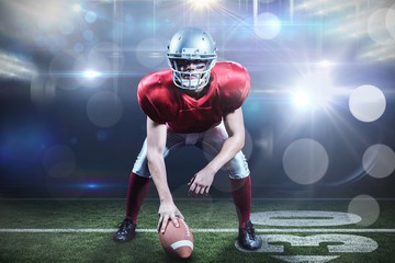Composite image of american football player holding helmet