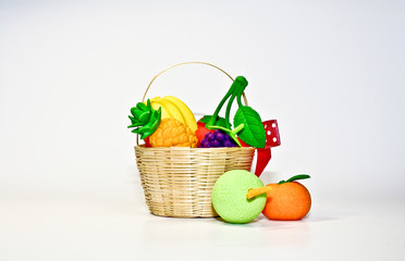 Artificial fruit in tiny basket