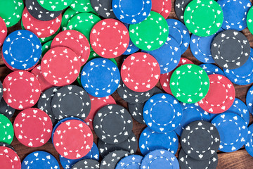 Poker chips over wooden background