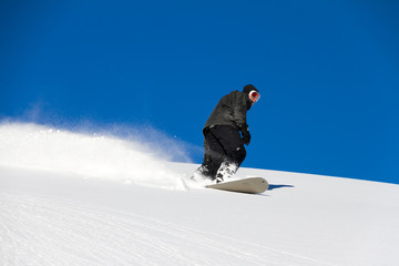 Awesome snowboarder is having fun in the backcountry powder of Les Portes du Soleil in France