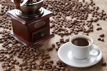  cup of coffee on a background coffee beans