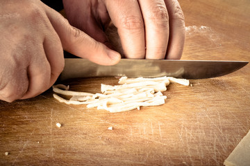 Womens hands in a process of preparing of dough for lagman. Tone