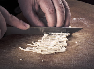 Womens hands in a process of preparing of dough for lagman. Tone
