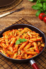 Penne with roasted chicken in tomato sauce