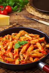 Penne with roasted chicken in tomato sauce