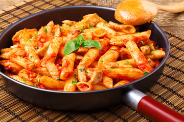 Penne with roasted chicken in tomato sauce