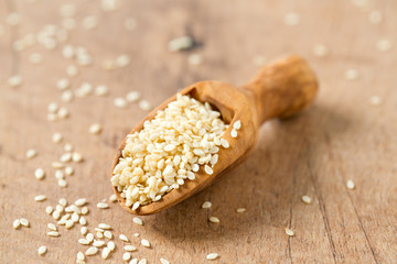 sesame seeds in a wooden scoop