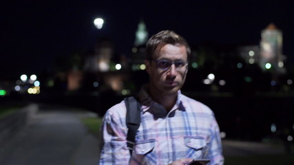 Lost man looking around and using smartphone, steadycam shot
 - Powered by Adobe