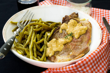 Pork chop with mustard sauce and green beans