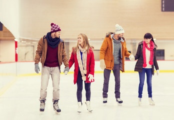 happy friends on skating rink