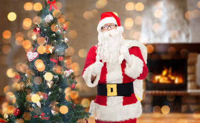 santa claus with bag showing thumbs up at home