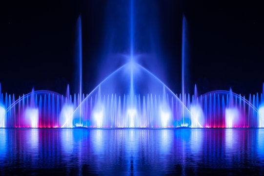 Musical fountain with colorful illuminations at night. Ukraine,