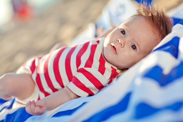 Little baby are joying the vacation on the beach in the evening