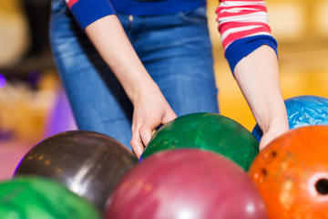 Fototapeta na wymiar close up of woman hands choosing bowling ball