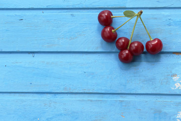 Ripe and fresh cherries on wooden background - still life 