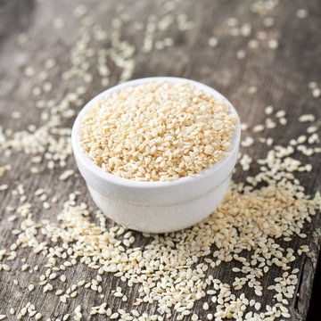 sesame seeds on wooden surface