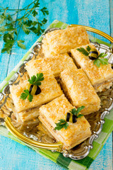 Napoleon cake appetizer on a wooden table
