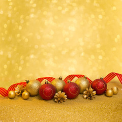 Christmas ornament with red and gold christmas balls on gold gli
