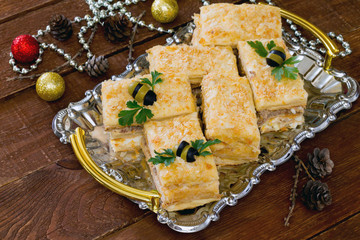Napoleon cake appetizer with fish, New Year's Eve