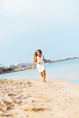 Happy beautiful woman running on the beach. 