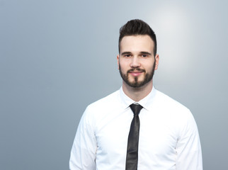 Friendly and smiling handsome businessman looking confidently at