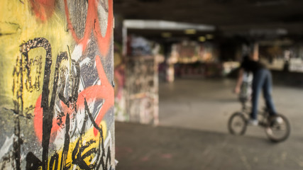 BMX Park. An urban concrete area adorned with graffiti and turned into a skate and BMX park in inner city London.