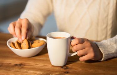 close up of woman with cookies and hot chocolate