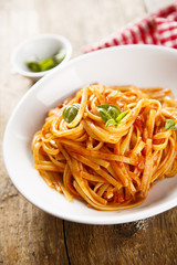 Pasta with vegetable sauce and green basil
