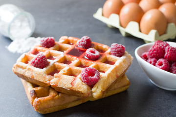 Waffles with raspberries and strawberry syrup