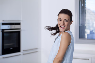 Young woman is sitting in the kitchen