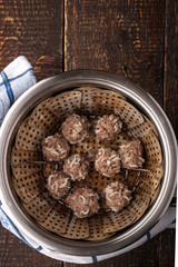 Meatball in the steamer on the wooden table top view