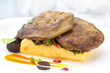 foie gras with corn bread on a table in a restaurant