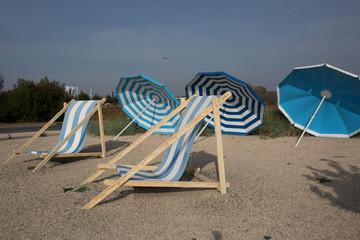 Beach scene. Colorful umbrellas lounge chairs