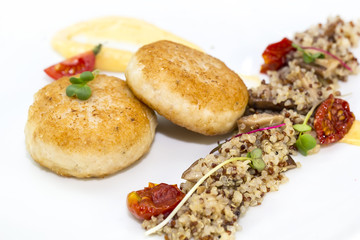 chicken cutlet with quinoa porridge on a table in a restaurant